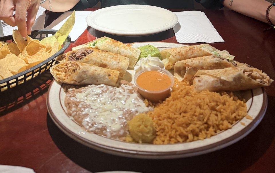 Mexican restaurant interior with tables and warm lighting.